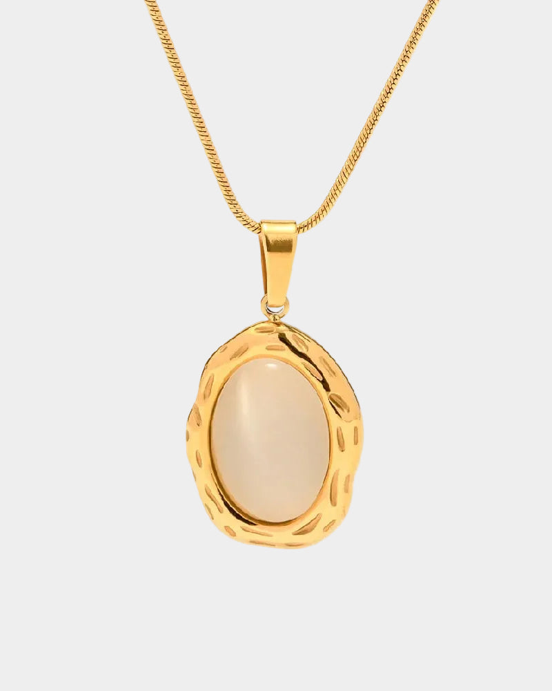 Gold pendant necklace with a beige stone on a white background